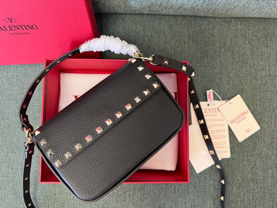Valentino: Black Valentino envelope-style small crossbody clutch bag with detachable shoulder strap, magnetic closure, and light gold stud embellishments. Dimensions: 13.5 x 19 x 3 cm. A wonderful gift for you o