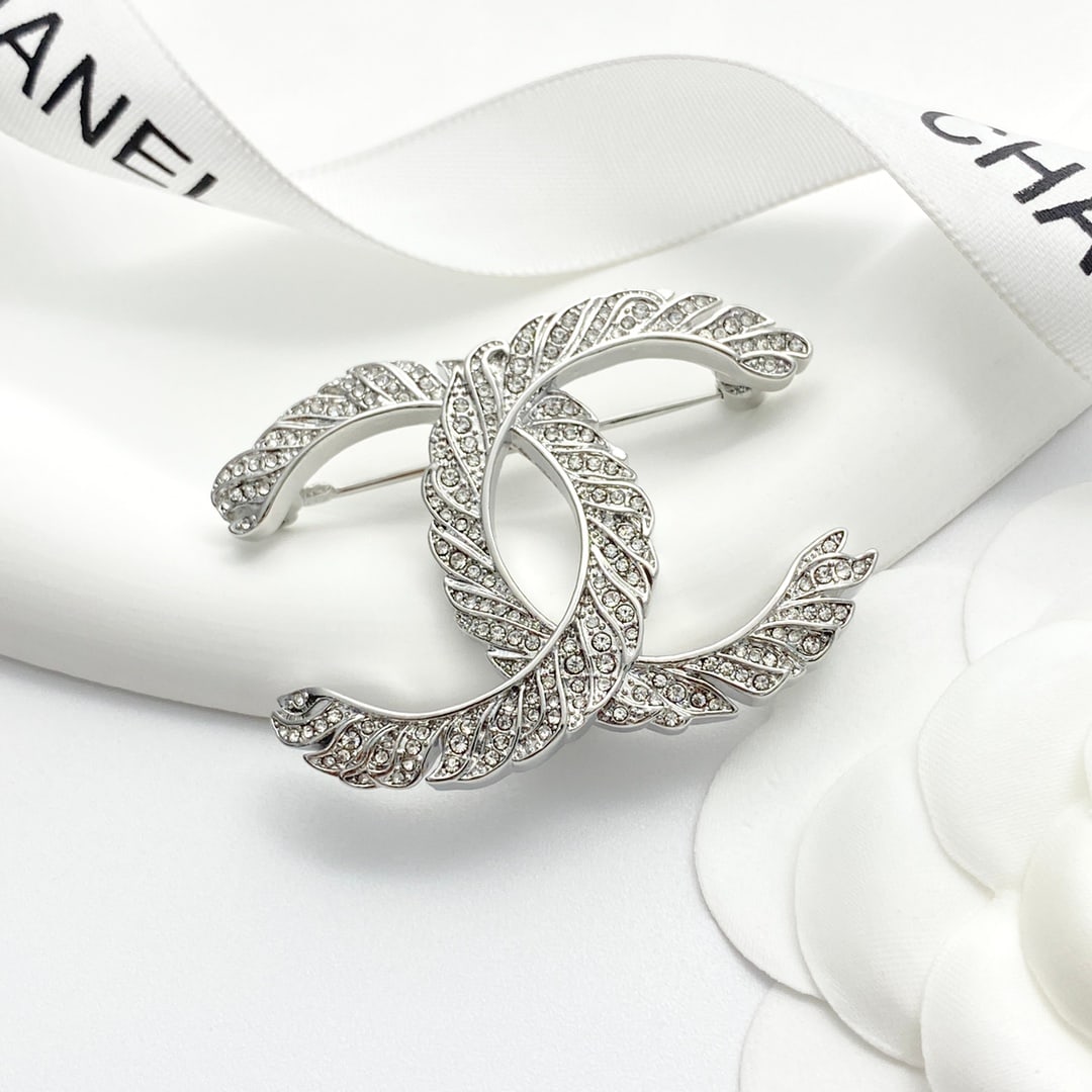 CHANEL Silver Fully Diamond Feather Double C Brooch: The CHANEL silver full-diamond feather double C brooch, composed entirely of diamonds and feathers, features a double C design with a regal feel. The color scheme is sophisticated and timeless, making