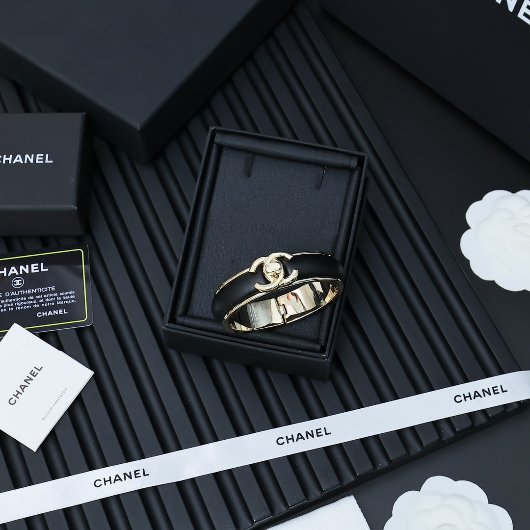 Chanel satin bag buckle lambskin bracelet: A Chanel satchel buckle lambskin bracelet a rare find, exuding chic and sophistication. This Chanel satchel buckle lambskin bracelet is a collector's item, versatile and elegant in black. A wonderful 