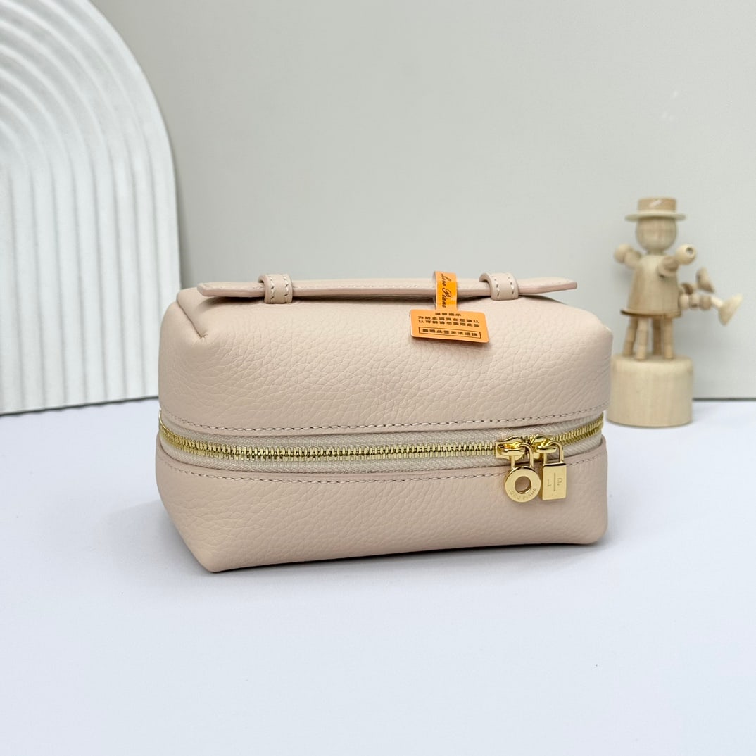 Loro Piana Makeup Bag: Loro Piana's cream-honey colored cosmetic bag features a wide opening design, crafted from calfskin with a canvas lining. Its spacious interior can hold everyday toiletries and cosmetics. It has a lea