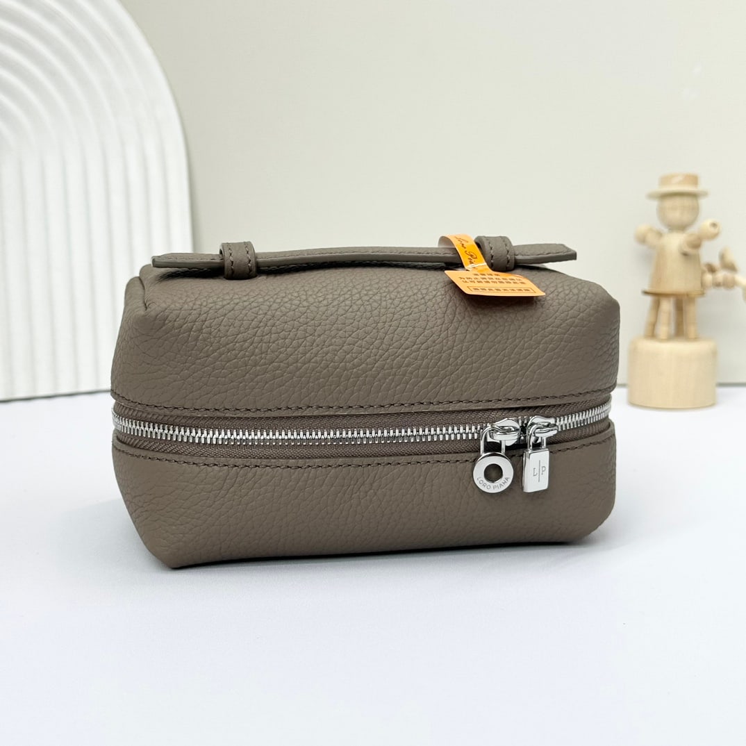 Loro Piana Makeup Bag: Loro Piana's warm beige cosmetic bag features a wide opening design, crafted from calfskin with a canvas lining. Its spacious interior can hold everyday toiletries and cosmetics. It has a leather hand