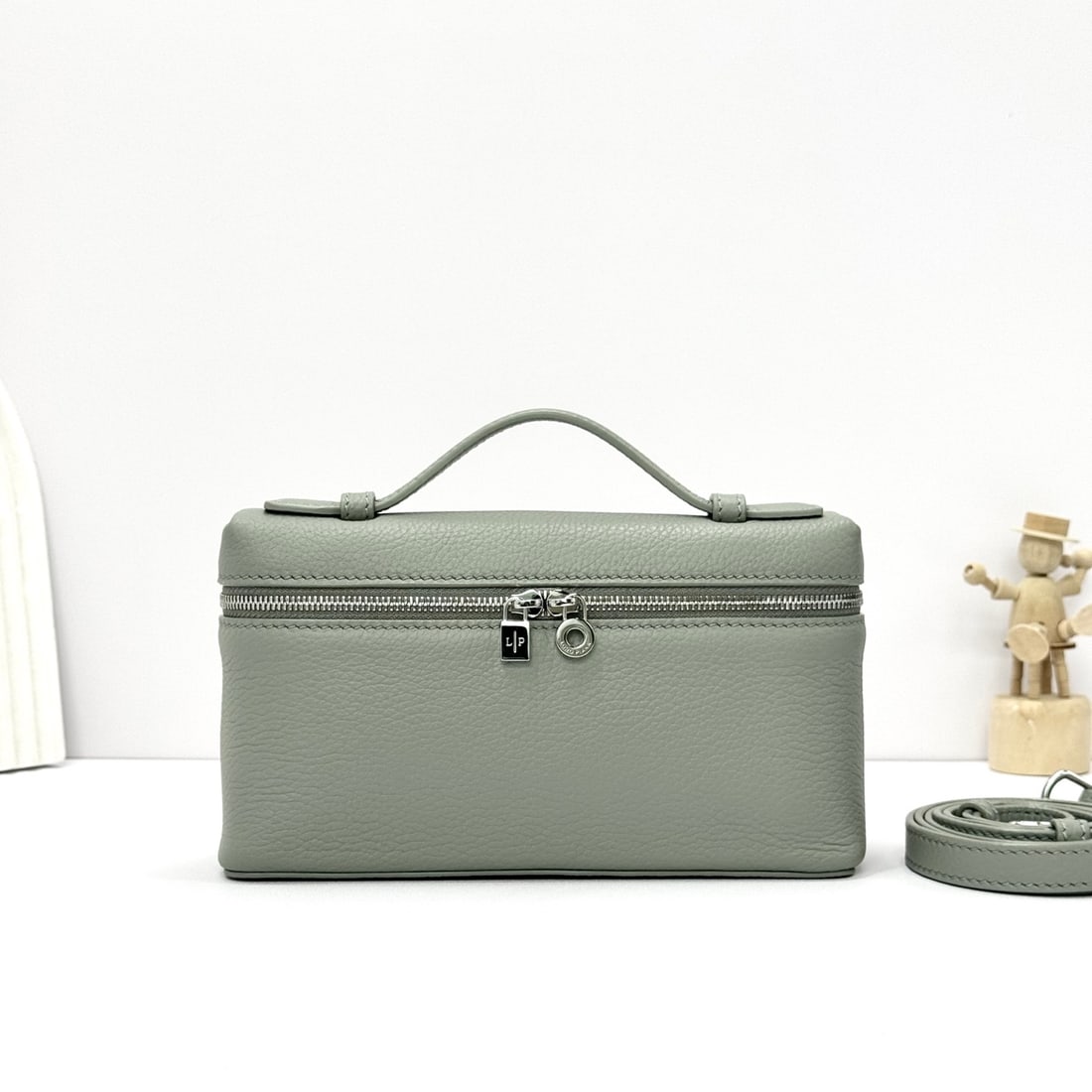 Loropiana Extra Pocket L19 Clutch: Loropiana Extra Pocket L19 in Bean Grey Green is a functional clutch with a wide opening, combining classic style with minimalist design. The bag is made of calfskin with a subtle hammered texture, an