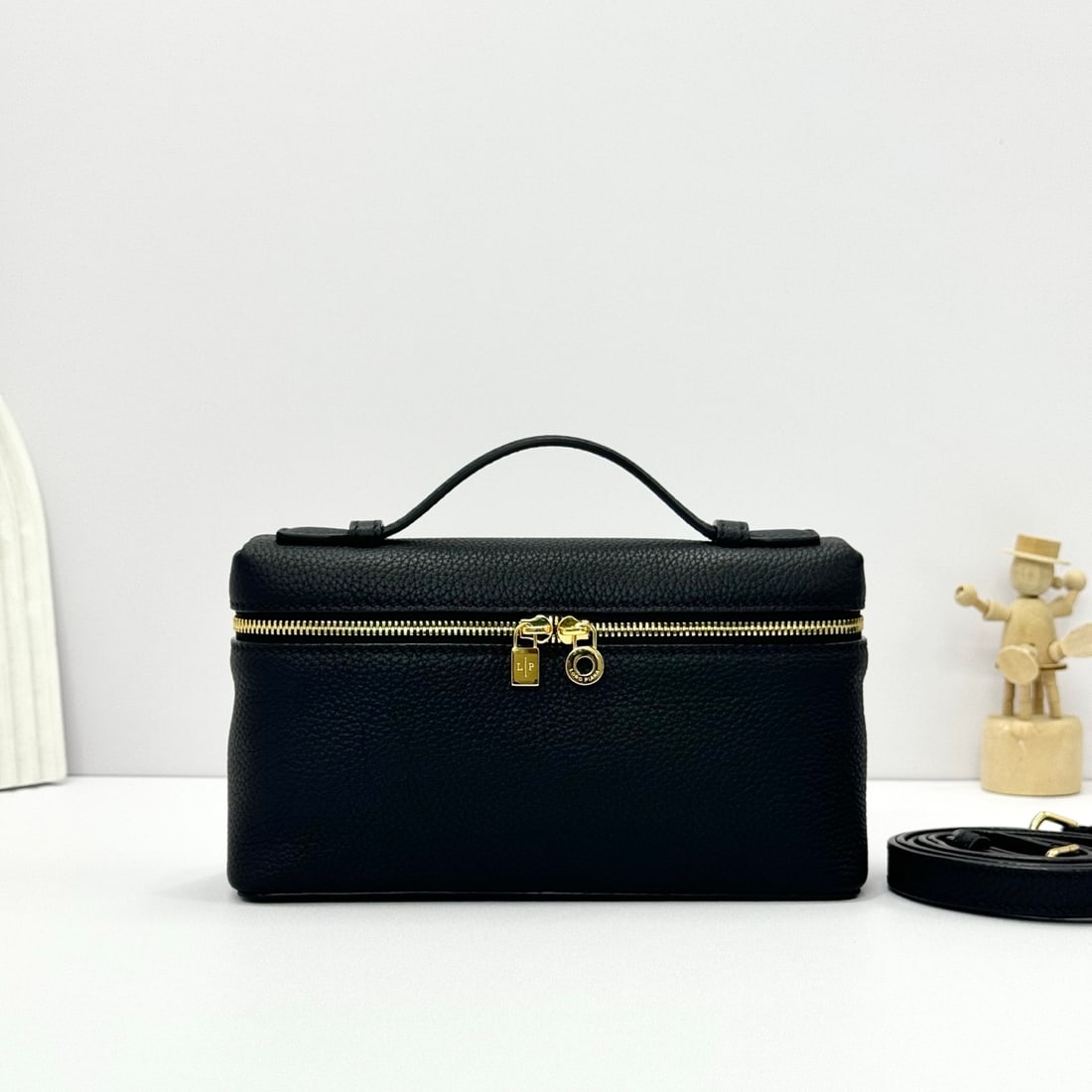 Loropiana Extra Pocket L19 Clutch: Loropiana Extra Pocket L19 Black with Gold Buckle: This is a functional clutch with a wide opening, combining classic style and minimalist design. The body is made of calfskin with a subtle hammered t