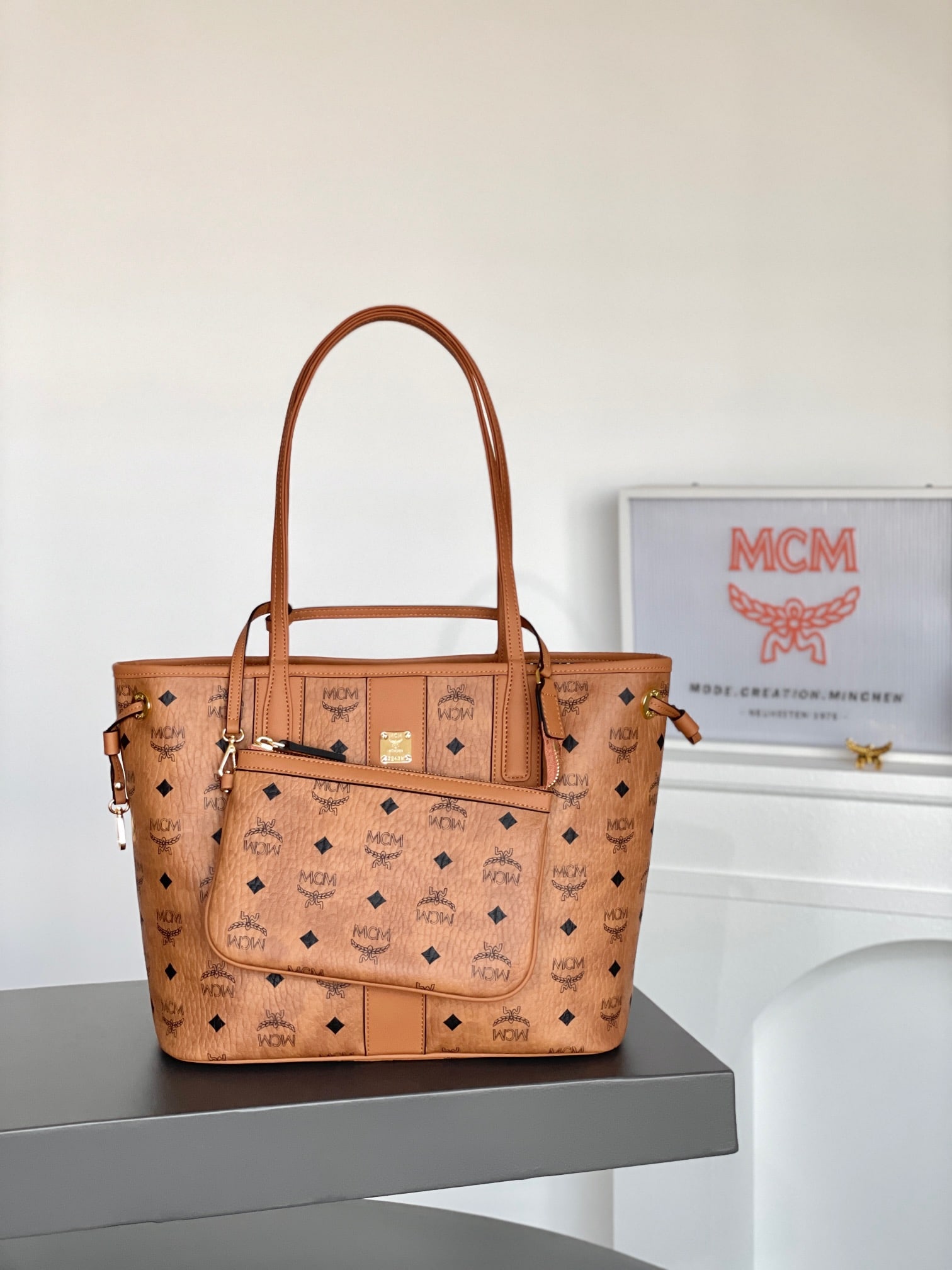 MCM Liz Visetos Small Reversible Shopping Bag Mother Bag: MCM Liz Visetos Small Reversible Shopping Bag (Mother Bag) in Classic Cognac Color. This is a signature two-in-one item. The compact Liz bag features a double-sided Cubic cotton canvas design, showcas