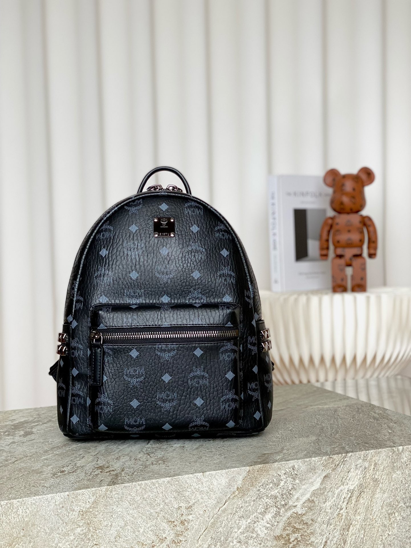 MCM Strak Visetos Small Studded Backpack: MCM Strak Visetos Small Studded Backpack, Black Monogram Canvas Print, Iconic Visetos, Black Coating. # Structured design with spacious interior and pyramid-shaped studded trim for a futuristic look. 