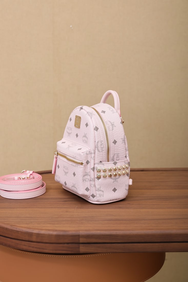 mcm strak visetos cherry blossom pink X-Min backpack: Show off your style with this ultra-mini Stark backpack in Cherry Blossom Pink with an all-over monogram print. Made from classic Visetos material, it features luxurious Nappa leather trim and edgy ne