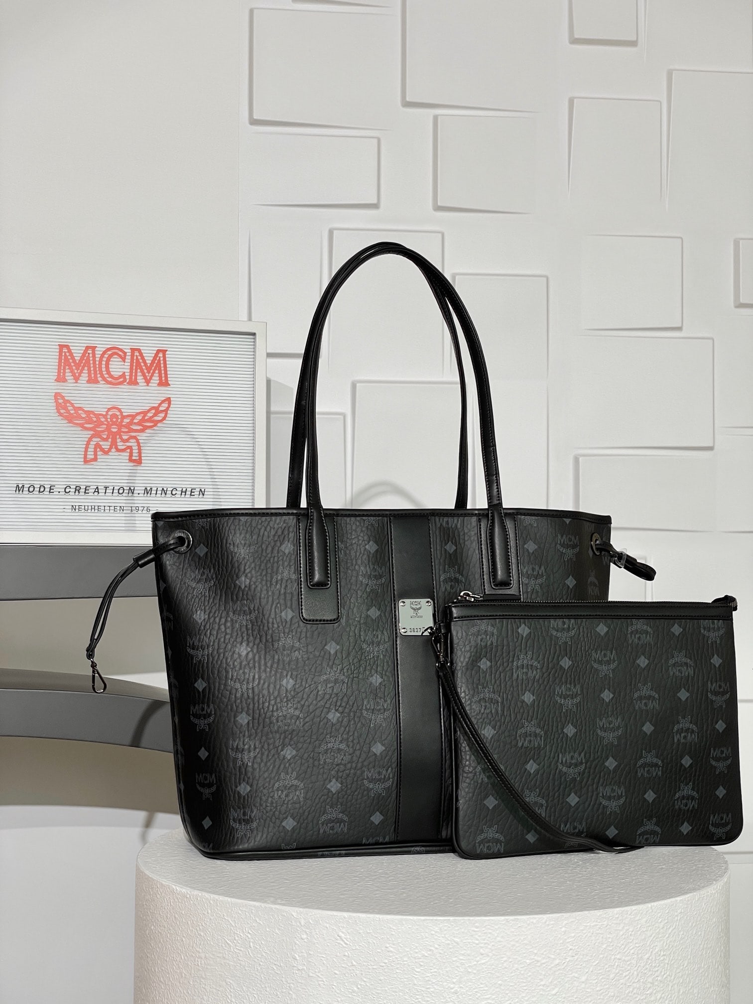 MCM Liz Visetos Medium Reversible Shopping Bag Mother Bag: The MCM Liz Visetos Medium Reversible Shopping Bag, featuring a black monogram print, combines two classic looks into one everyday item. Made from Visetos and Nappa leather, this medium-sized Liz shop