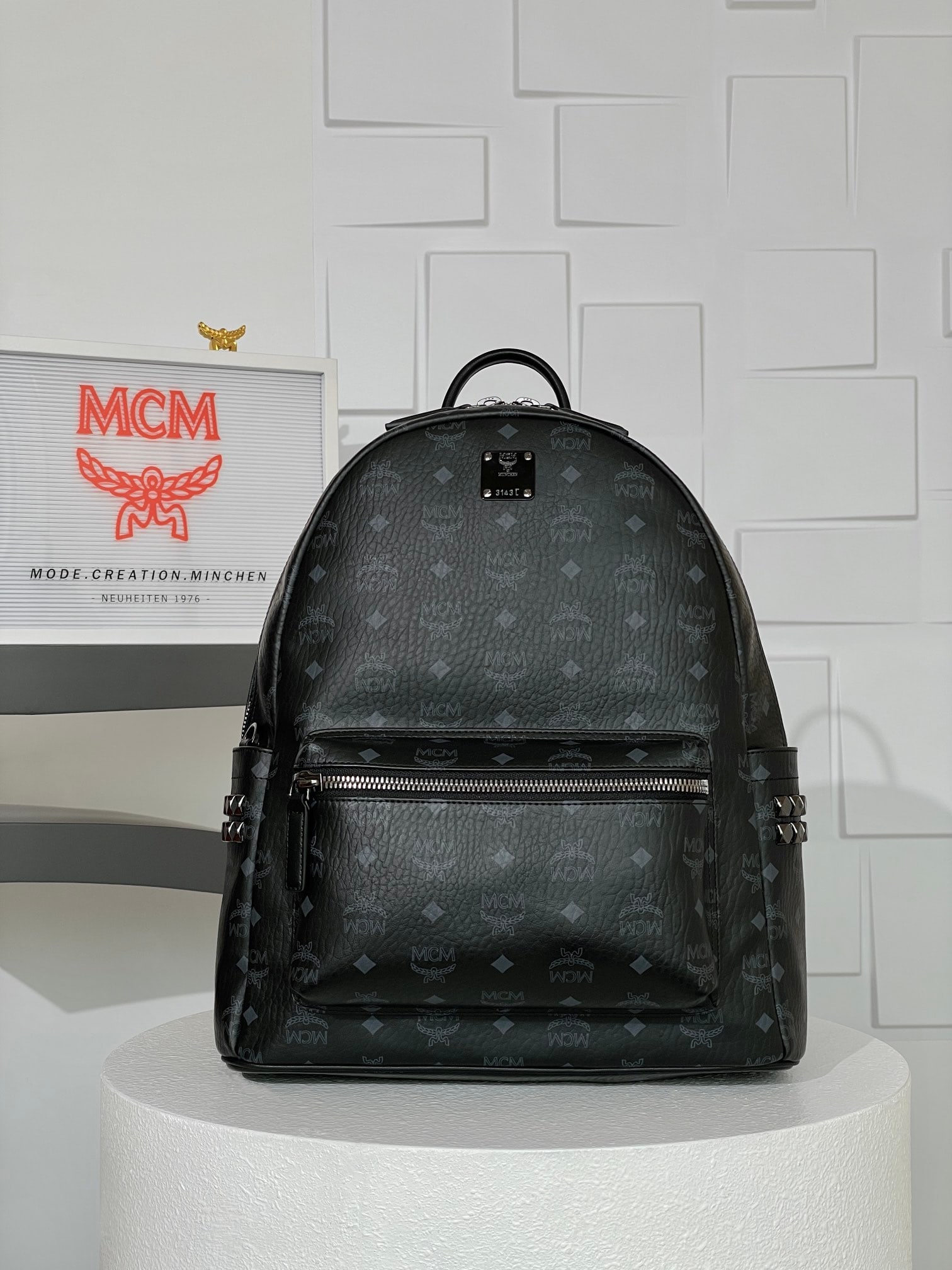 MCM Strak Visetos Medium Studded Backpack: MCM Strak Visetos Medium Studded Backpack, Black Monogram All-over Print, Unisex Bag. This backpack boasts a well-structured design, crafted from classic Visetos material and trimmed with luxurious