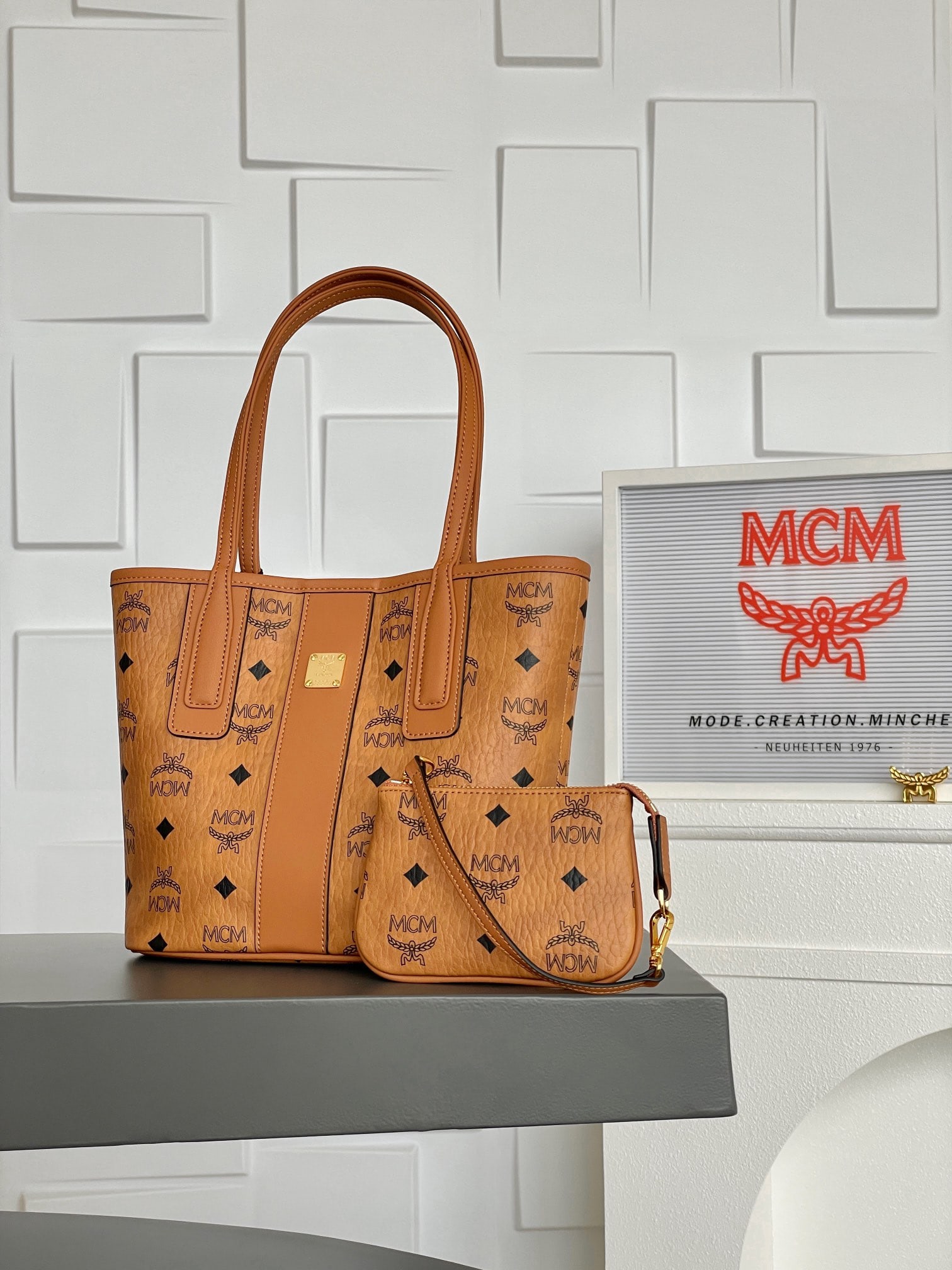 MCM LIZ VISETOS Mini Reversible Shopping Tote Bag: MCM LIZ VISETOS Mini Reversible Tote Bag in Classic Cognac Color. Classic MCM minimalism is presented through a modern, minimalist design. This mini tote bag is a scaled-down version of the iconic Liz