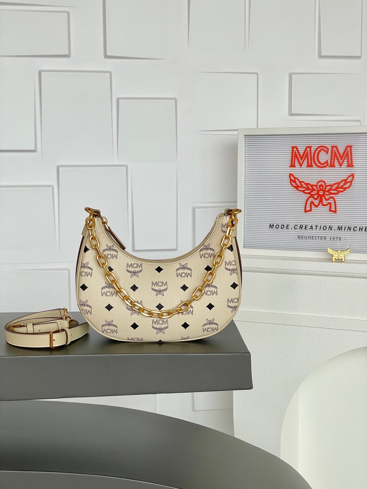 MCM AREN HOBO Off-white Small Half-Moon Bag Shoulder Bag: MCM AREN HOBO Beige Small Half-Moon Bag Crossbody Bag - New Arrival! This curved Hobo bag, inspired by the moon, is crafted from iconic Visetos and Nappa leather and features a modern beige finish.