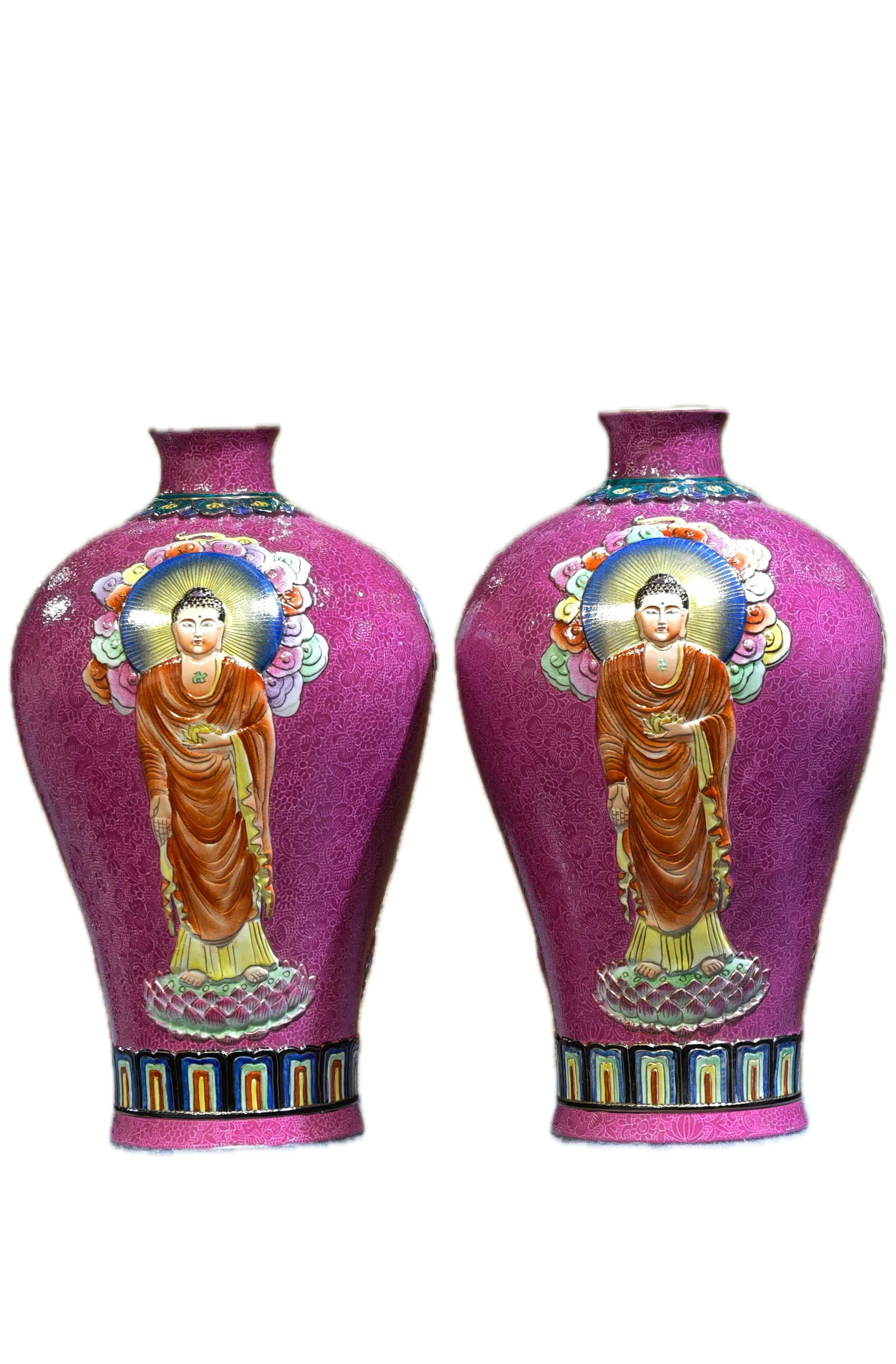 A pair of plum vases with a rouge-red glaze and relief carving of the Western Three Saints, bearing: A pair of plum vases with a rouge-red glaze and relief carving of the Western Three Saints, bearing the mark "Made in the Qianlong Reign of the Great Qing Dynasty," measuring 40 cm in height and 23 cm