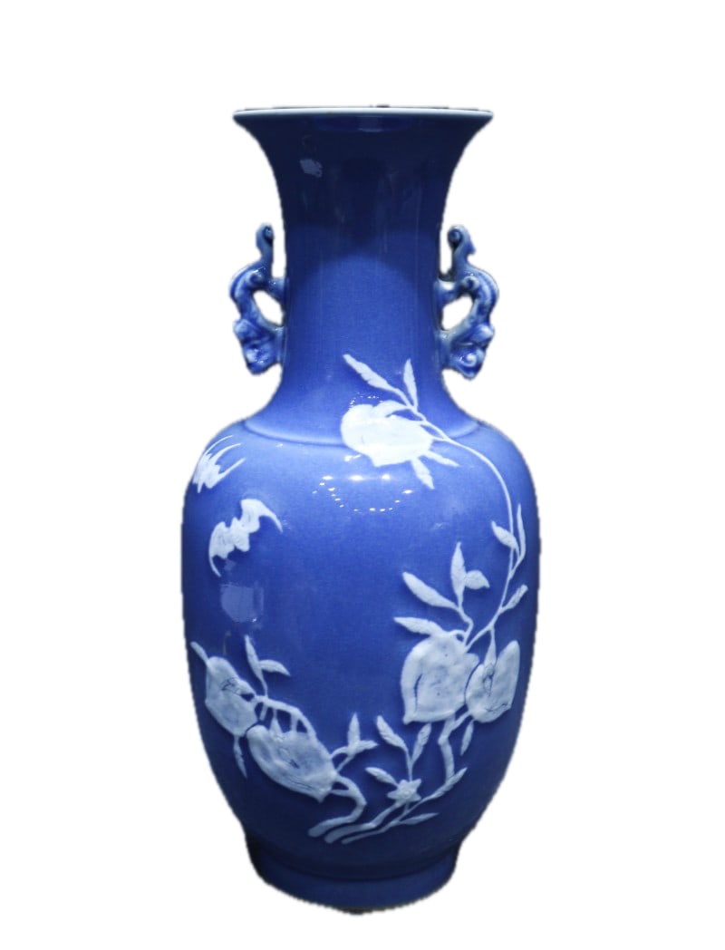 A sapphire blue glazed glass vase with white molded auspicious and longevity motifs and handles,: A sapphire blue glazed glass vase with white molded auspicious and longevity symbols and handles, bearing the mark "Made in the Qianlong Reign of the Great Qing Dynasty," measuring 29 cm in height and