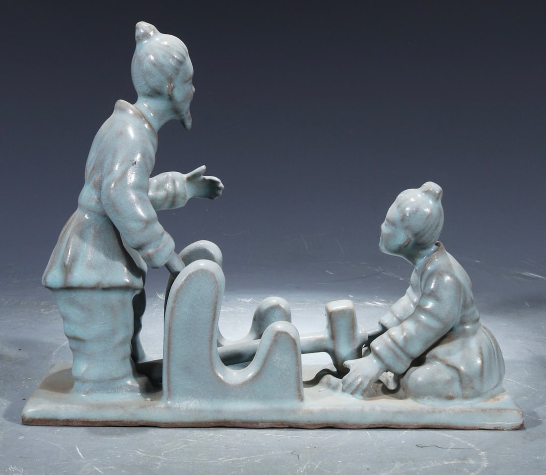 A celadon-glazed figure ornament from Ru ware, one of the five great kilns of the Song Dynasty,: A celadon-glazed figure sculpture from the Ru kiln, one of the five great kilns of the Song Dynasty, formerly in the collection. 17 cm high, 21.5 cm wide. Provenance:From a noted private collection in