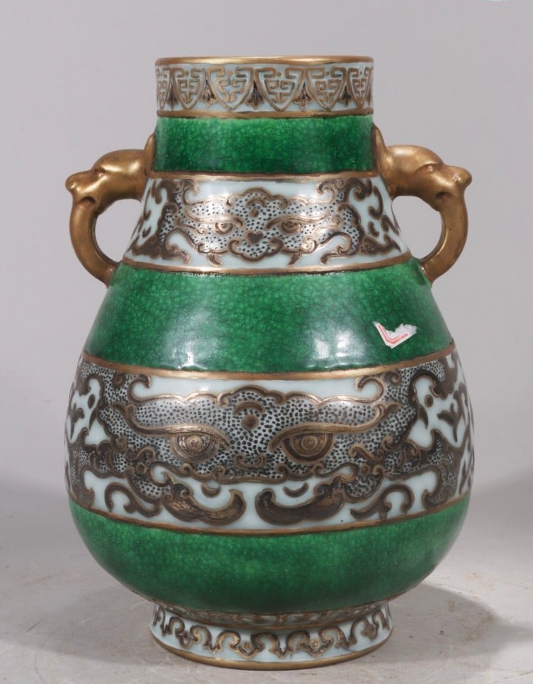 A vase with crackle glaze and gilt animal mask design, formerly in the collection and bearing the: A vase with a crackle glaze and gilt animal mask design, formerly in the collection and bearing the mark "Made in the Qianlong Reign of the Great Qing Dynasty," measuring 23.5 cm in height and 16.5 cm