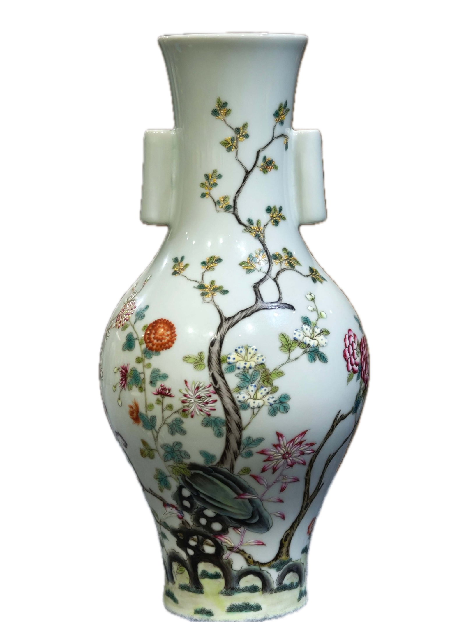 A celadon-glazed vase with floral design and tubular handles, bearing the mark "Made in the: A celadon-glazed vase with floral design and tubular handles, bearing the mark "Made in the Yongzheng Reign of the Great Qing Dynasty," 32 cm high and 16 cm wide. Provenance:From an old private estate
