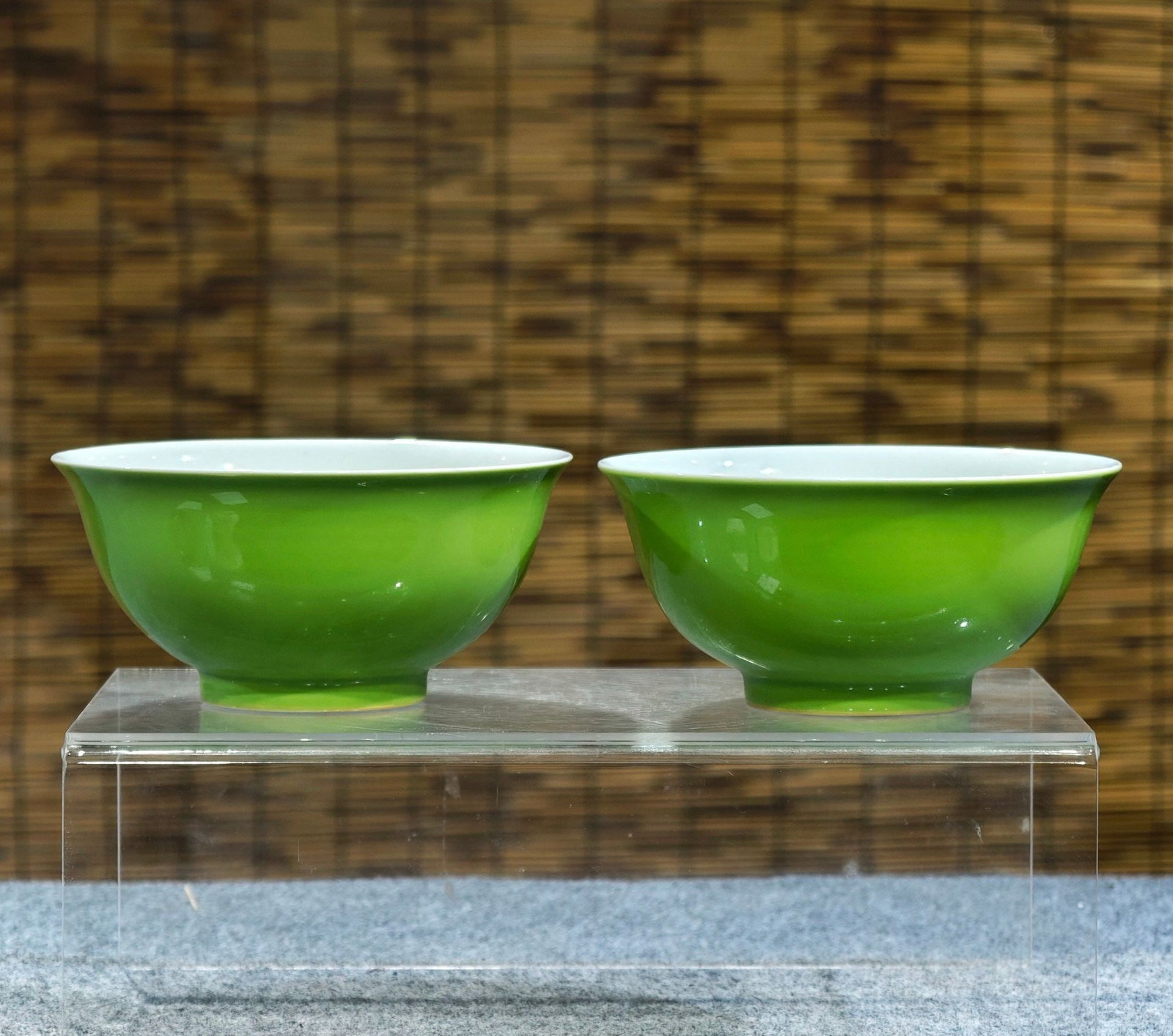 A pair of monochrome apple-green bowls with painted figures and stories inside, bearing the mark: A pair of monochrome apple-green bowls with painted figures and stories inside, formerly in the collection and bearing the mark "Made in the Yongzheng Reign". 8 cm high, 16 cm wide. Provenance:Private