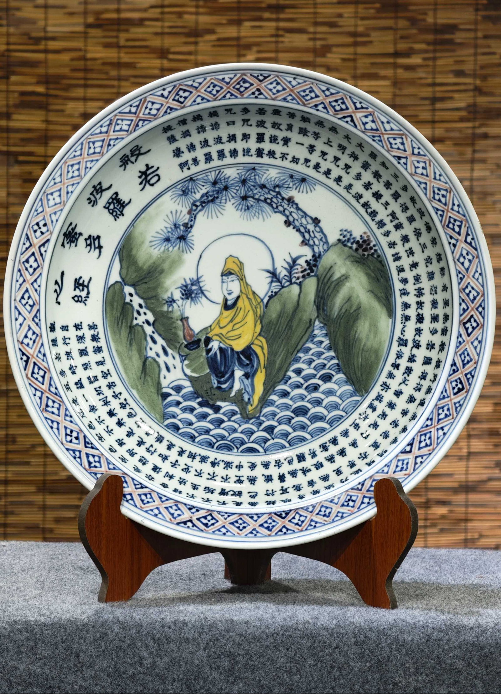 A Ming Xuande period underglaze blue and white porcelain plate with polychrome glaze and jackfruit: Ming Xuande period underglaze blue and white porcelain plate with polychrome famille rose decoration and the Heart Sutra, 45 cm in diameter. Provenance:Private collection from a professor in Heidelber