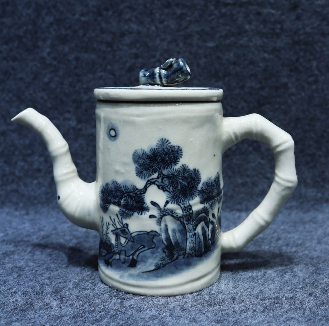 A blue and white porcelain teapot with a landscape and bamboo design, bearing the mark "Made in the (1 of 9)