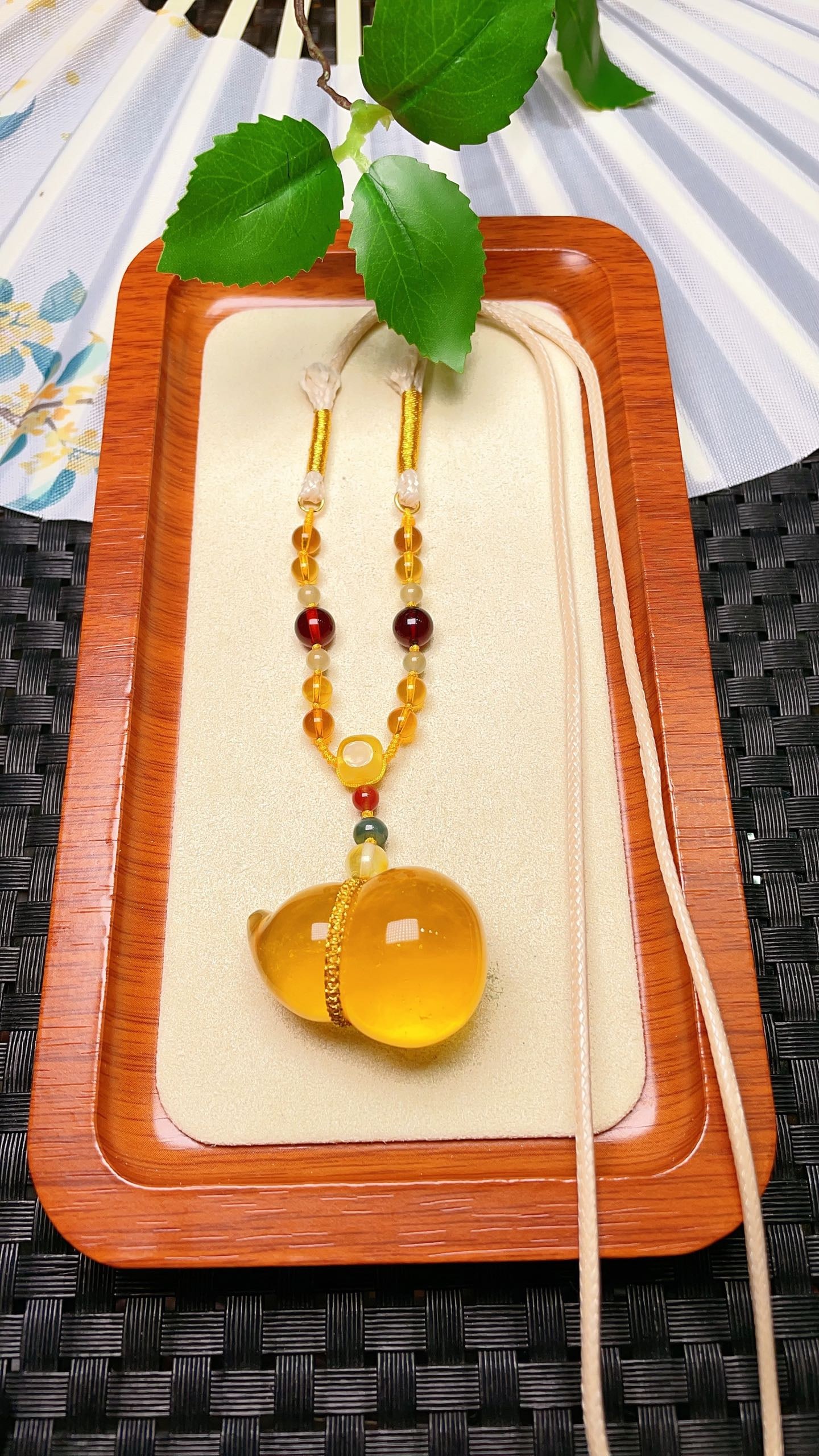 Original handmade custom natural amber gourd pendant: Original handmade natural amber gourd pendant with a lustrous, oily sheen. Dimensions: 35.5 x 24 mm. Comes with a natural multi-gem cord. Pendant weight: 10g. Total weight: 14.5g. Simple, elegant, and