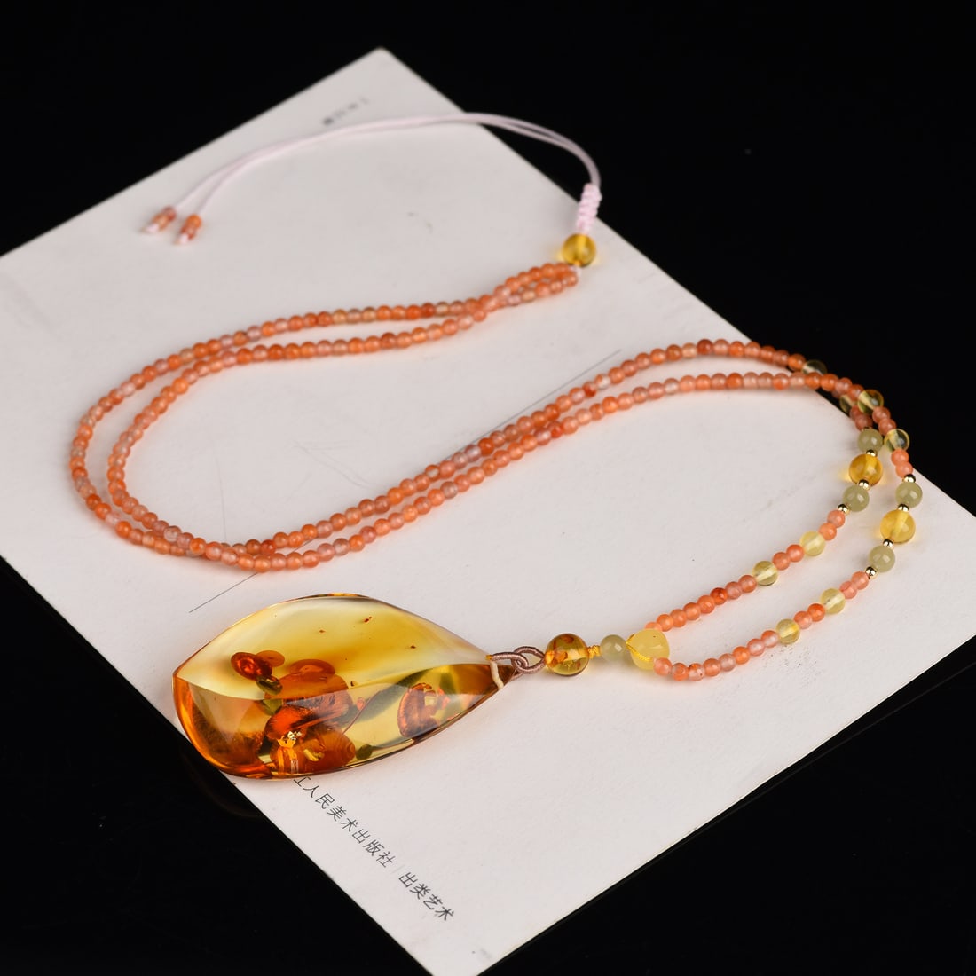 Original handmade custom natural amber teardrop pendant: Original handmade natural amber teardrop pendant with a lustrous, oily sheen. Dimensions: 49.1 x 32.9 x 12 mm. Paired with a natural red agate multi-gemstone chain. Total weight: 14.6g. Simple, elegan