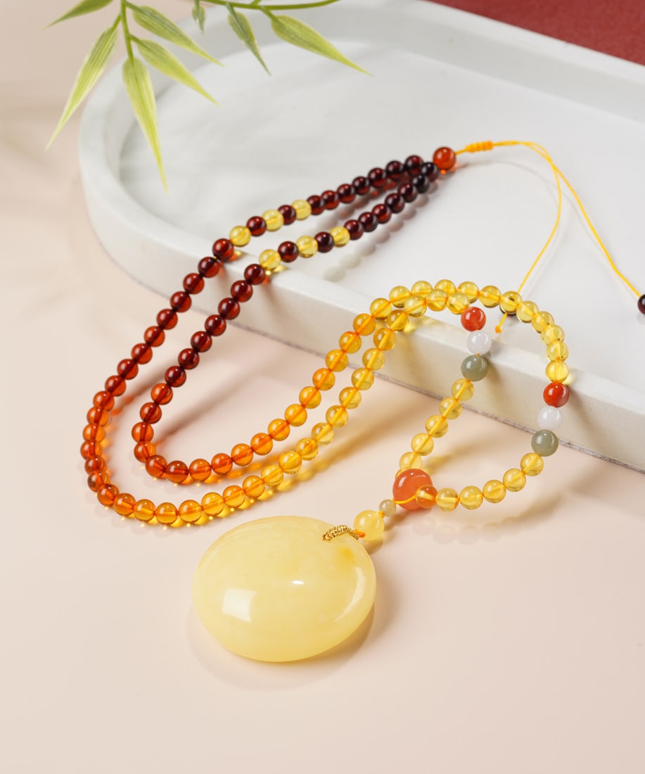 Original handmade custom natural amber princess clasp pendant: Original handmade natural amber princess clasp pendant with a lustrous, oily sheen. Dimensions: 40.3 x 16.2 mm. Comes with a natural rainbow gemstone chain. Pendant weight: 15.5g, total weight: 27.8g.