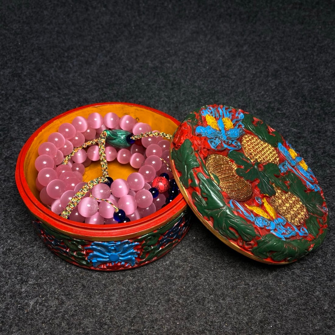 A cat's-eye stone court bead is treasured inside a lacquer jewelry box made for the imperial court. (1 of 10)