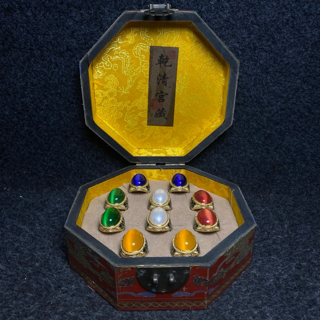 cat's eye stone ring was placed inside a lacquerware collection box made by Emperor Qianlong of the: A Qing Dynasty Qianlong Emperor Imperial Lacquerware Collection Box containing a cat's-eye stone ring. Dimensions: 18/18/8cm (L/W/H). Provenance:Private collection from a professor in University of Ca