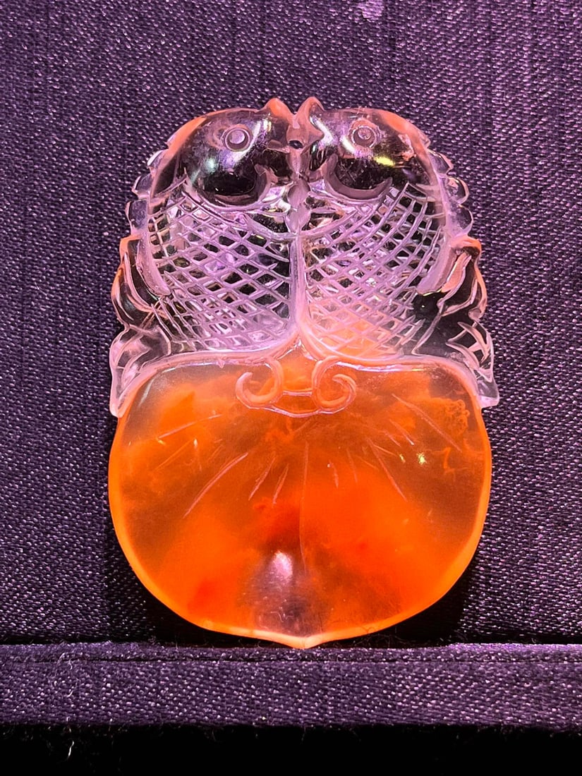 Natural red crystal double fish pendant: This natural red crystal double fish pendant symbolizes good fortune, abundance year after year, wealth, and prosperity. It is believed to bring the wearer smooth sailing and peace. Red crystal is ass