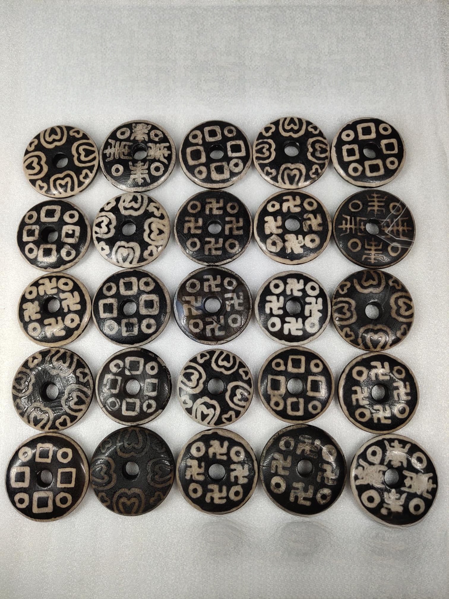 Treasured Collection of 25 Agate Dzi Bead Safety Buckles: This is a collection of 25 heirloom agate dzi bead safety buckles, ranging from 5.0 to 4.0 cm in diameter and 1.0 to 0.9 cm in thickness, each weighing 39-25 g. Provenance:Private collection from a pr