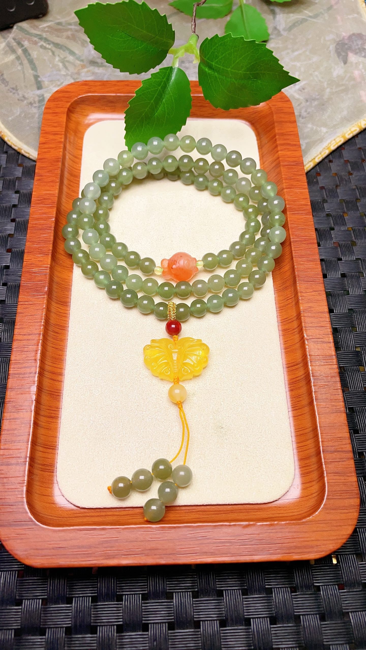Original handmade custom natural jade three-strand bracelet: Original handmade natural jadeite three-strand bracelet with a lustrous sheen, 6mm in diameter, featuring a natural red agate fish and a natural amber butterfly design. Stylish and versatile. Provenan