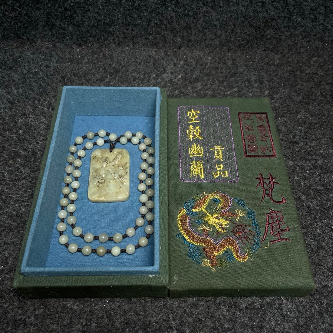 A precious natural Hetian jade necklace is housed in a royal embroidery collection box.: A precious natural Hetian jade necklace housed in a royal embroidery collection box. Necklace dimensions: 8mm in diameter. Box dimensions: 20 x 11 x 6cm (length x width x height). Provenance:Private c
