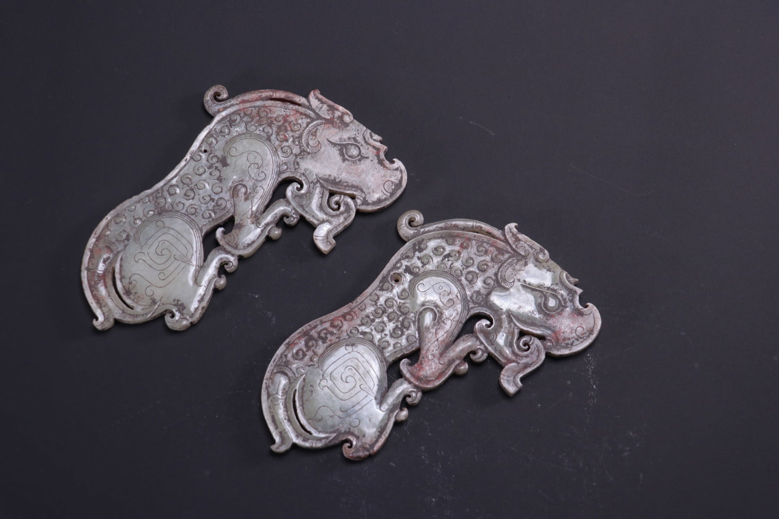 A pair of ancient jade tiger-shaped pendants from a former collection: A pair of ancient jade tiger-shaped pendants from a former collection. Dimensions: Length 13.3cm, Width 8.2cm, Thickness 0.6cm, Total Weight 200g. Provenance:Private collection, Liverpool, The United 