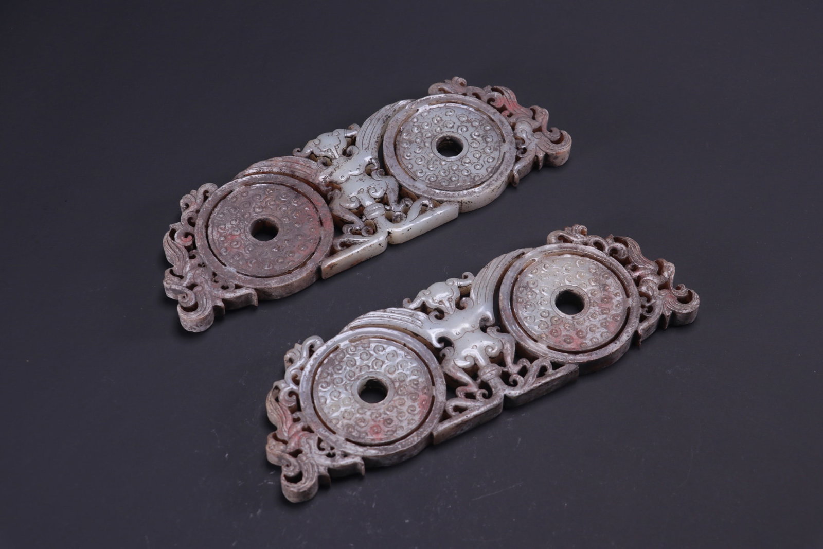 A pair of ancient jade pendants with dragon and phoenix designs, formerly in the collection: A pair of ancient jade pendants with dragon and phoenix designs, formerly in the collection. Dimensions: Each pendant is 19cm long, 6.3cm wide, and 1cm thick. Total weight: 483g. Provenance:Private co
