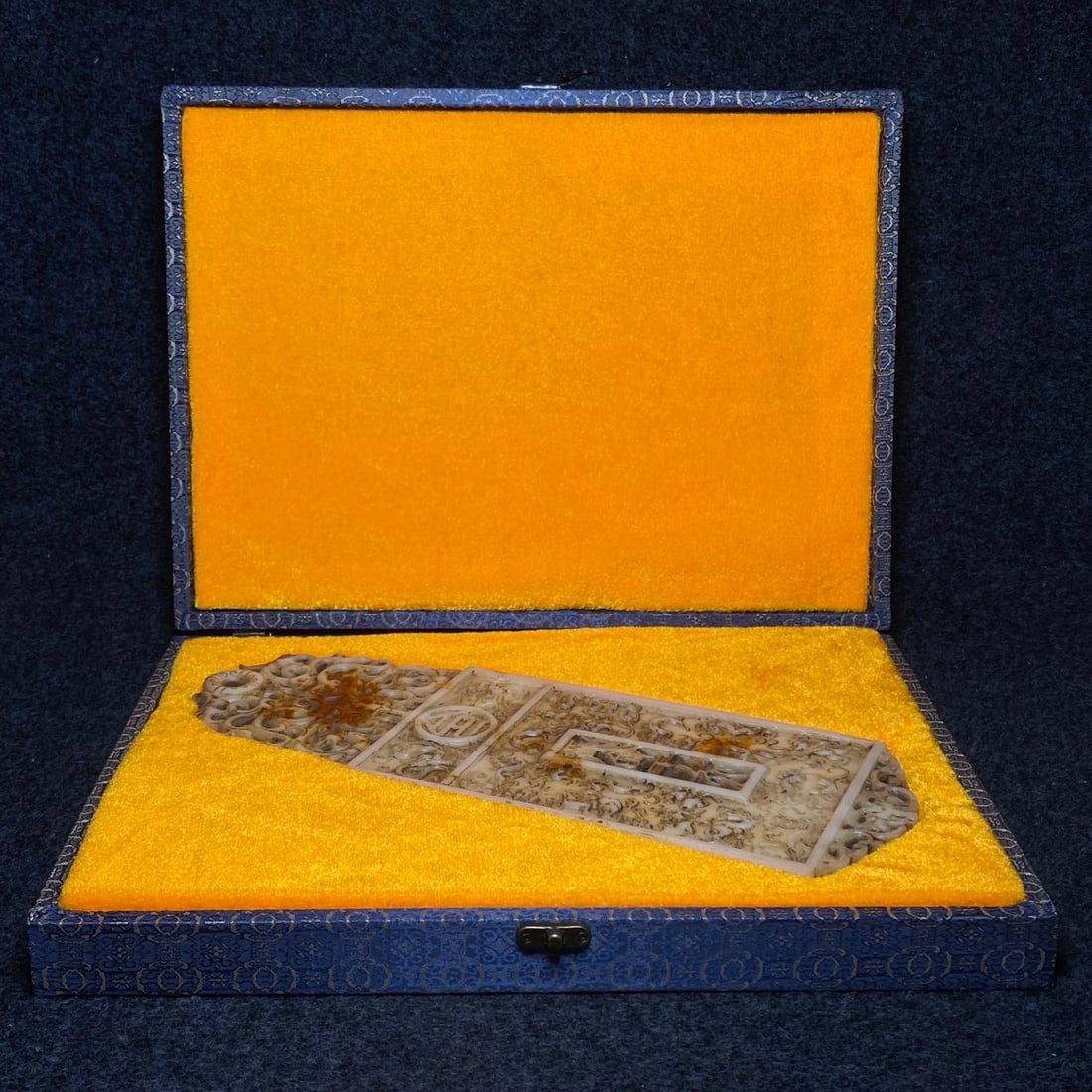 The brocade box contains an ancient jade disc.: The jade disc, housed in a brocade box, measures 35 x 12.2 x 1.3 cm (length x width x thickness). The box itself measures 38 x 28 x 5 cm (length x width x height). Provenance:Private collection, Liver