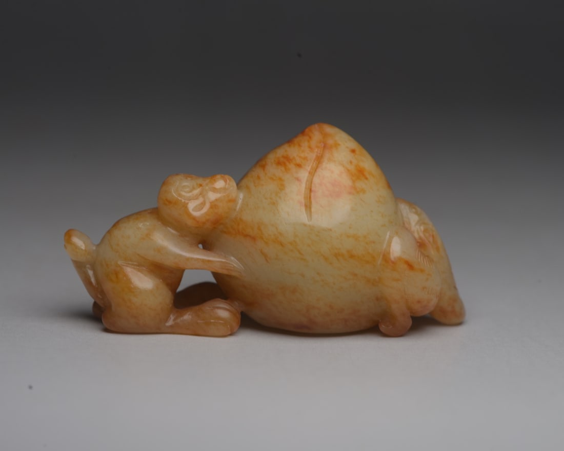 Hetian Jade Monkey Offering Longevity: Hetian jade monkey offering longevity symbol measures 6.2 x 3.1 x 2.8 cm and weighs 57 g. Provenance:Private collection from a professor in The University of Edinburgh. We warmly invite collectors, co