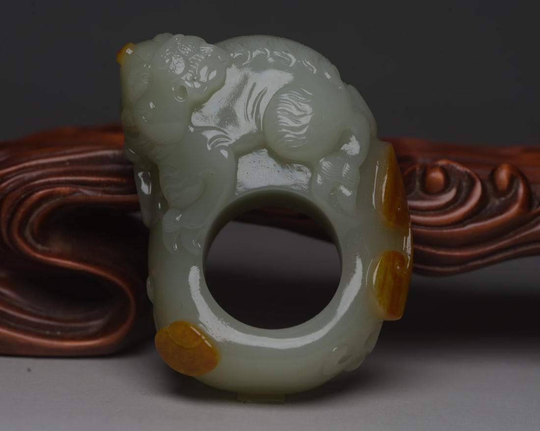 Hetian jade thumb ring: Specifications of Hetian jade thumb ring: outer diameter 5.7 cm, inner diameter 2.3 cm, height 2.0 cm, weight 72 g. Provenance:Private collection from a professor in The University of Edinburgh. We wa