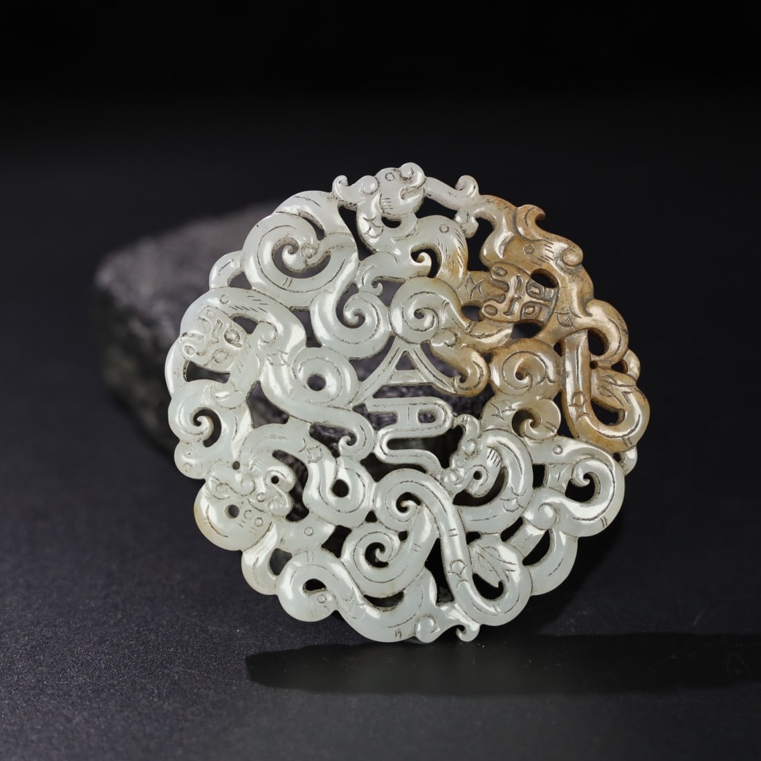 Former Collection of Hetian Jade Dragon Pendant: The old Hetian jade dragon pendant is of fine and oily texture with a well-developed patina. It measures 8.5cm in diameter, 1cm in thickness, and weighs 103g. Provenance:Private collection from a prof