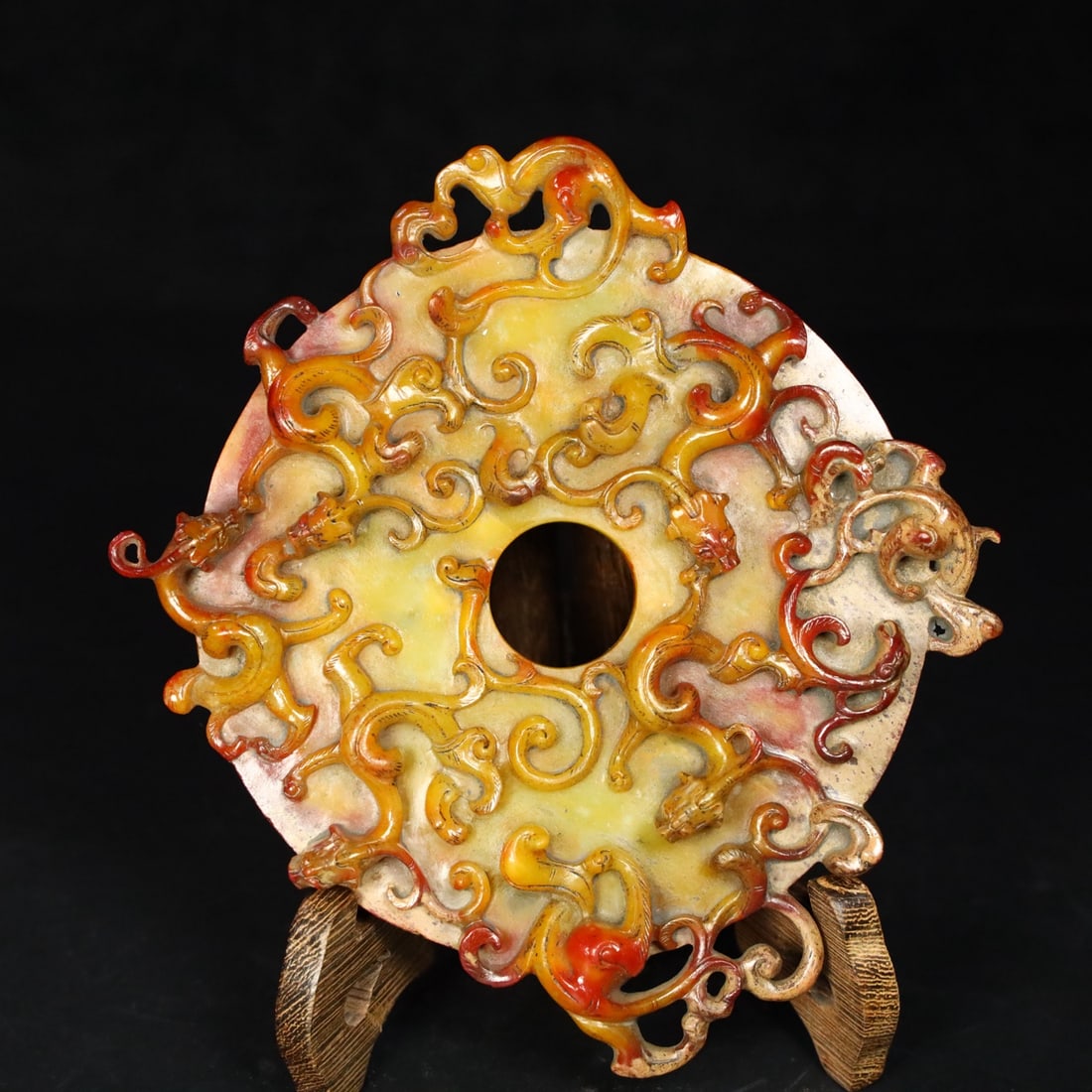 Former Collection of Hetian Jade Dragon Wall: This old Hetian jade dragon bi disc is of fine, oily texture with a well-developed patina. Details are shown in the pictures. It measures 16.3cm in length, 2cm in height, and weighs 373.9g. Provenance