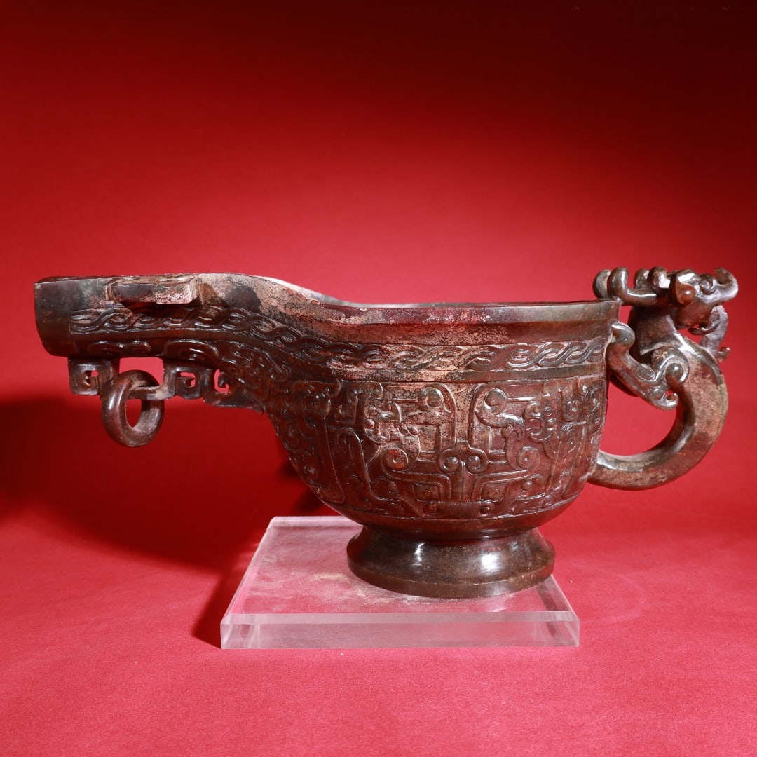Warring States and Han Dynasty Hetian yellow jade round carving of a large dragon pattern wine: A large, fully carved dragon-patterned wine cup/vessel made of Hetian yellow jade from the Warring States period (Han Dynasty). 15cm high, 33cm long, 16cm wide, weighing 2117g. Provenance:Private coll