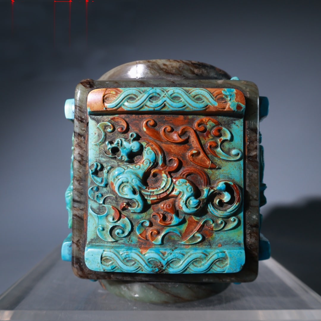 Warring States and Han Dynasty Hetian jade inlaid with Azure Dragon, White Tiger, Vermilion Bird,: A large Hetian jade ornament inlaid with Azure Dragon, White Tiger, Vermilion Bird, and Black Tortoise from the Warring States period and the Han Dynasty. It is 11cm high, 10cm wide, and weighs 1493g.