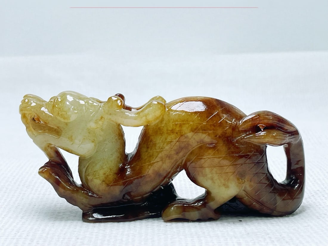 A treasured Hetian jade dragon hand-held piece made from pebble material.: A rare Hetian jade dragon hand-held piece made from pebble material. Dimensions: 9.5 x 4 cm, Weight: 98g Provenance:Private collection from a professor in University College London. We warmly invite c