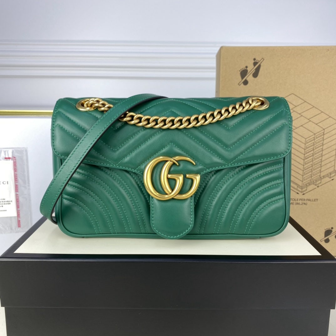 GUCCI MARMONT Emerald Green: We offer FREE SHIPPING for both domestic and international clients who bid over $500. The GUCCI MARMONT medium-sized bag in emerald green boasts a structured yet supple shape and an oversized flap clo