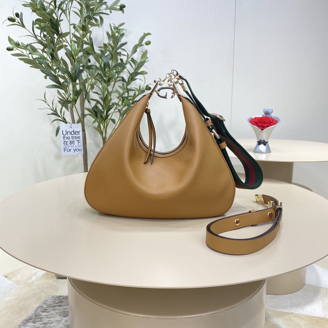 GUCCI Attache: We offer FREE SHIPPING for both domestic and international clients who bid over $500. The Attache collection's large shoulder bag in brown offers a fresh take on the brand's iconic elements, paying ho