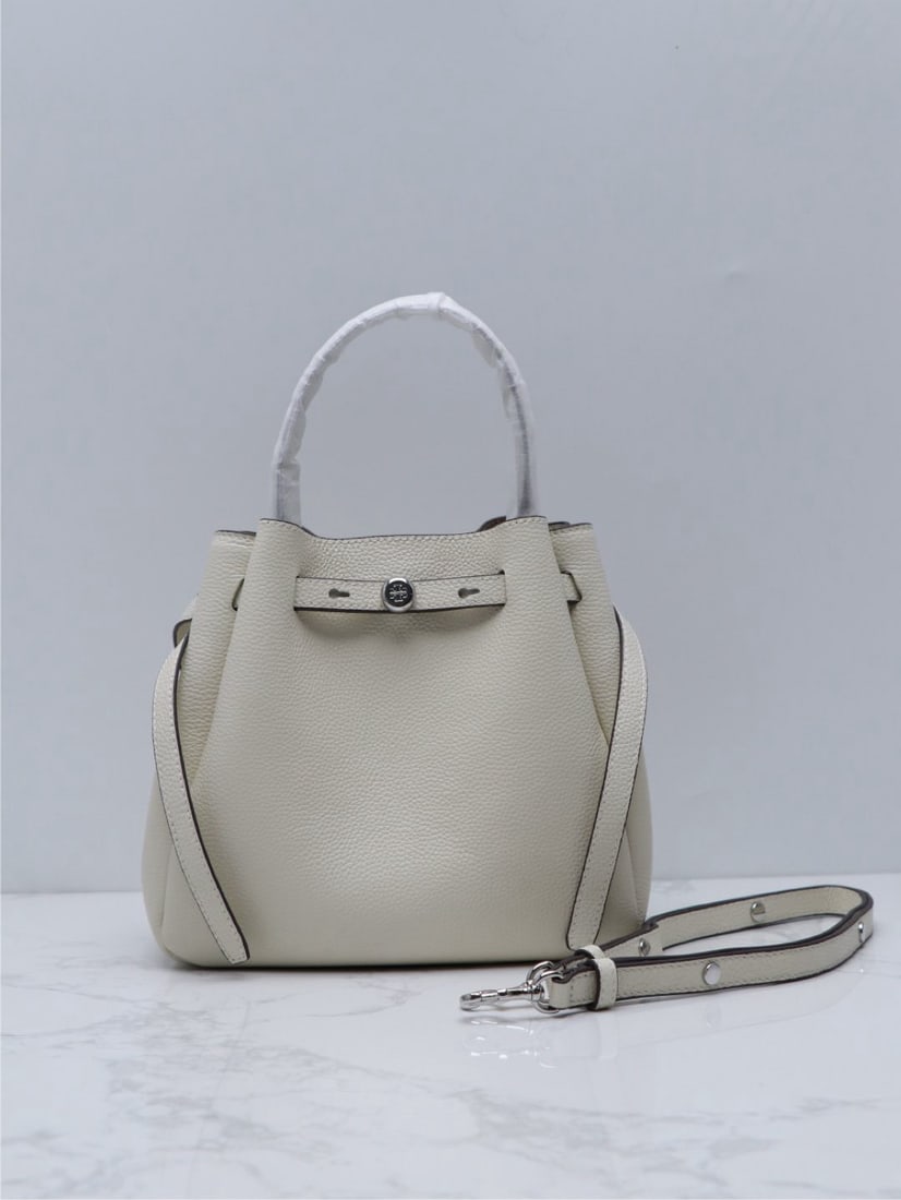 Tory Burch Romy: We offer FREE SHIPPING for both domestic and international clients who bid over $500. The Tory Burch Romy bucket bag is crafted from supple leather, featuring a streamlined silhouette and a cleverly c