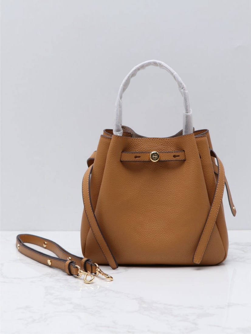 Tory Burch Romy: We offer FREE SHIPPING for both domestic and international clients who bid over $500. The Tory Burch Romy bucket bag is crafted from supple leather, featuring a streamlined silhouette and a cleverly c
