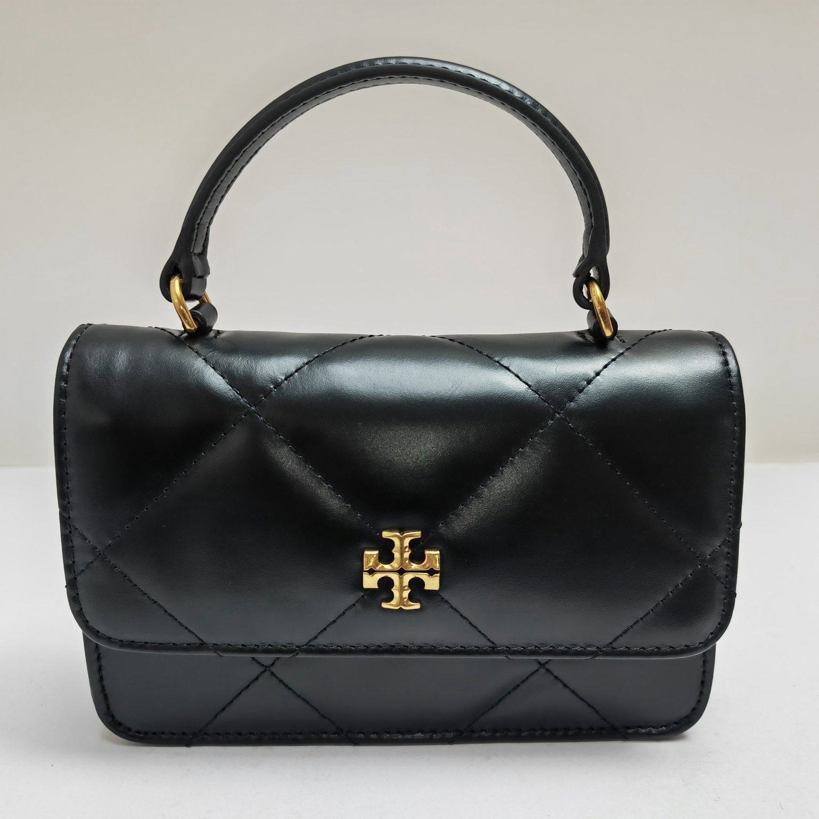Tory Burch Kira: We offer FREE SHIPPING for both domestic and international clients who bid over $500. Black Kira mini handbag with diamond quilting, made of top-grain leather with a longitudinal diamond quilting patt