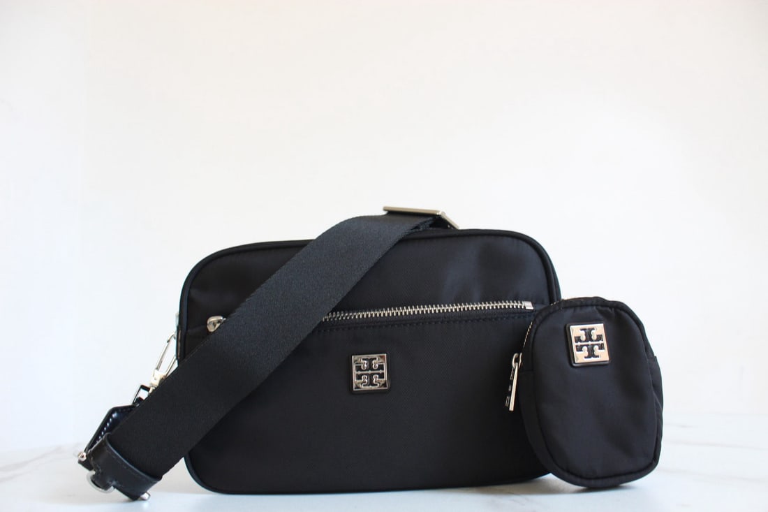 Tory Burch Virginia: We offer FREE SHIPPING for both domestic and international clients who bid over $500. The black Tory Burch Virginia nylon messenger bag/camera bag offers a fresh take on 90s classic style. Made from s