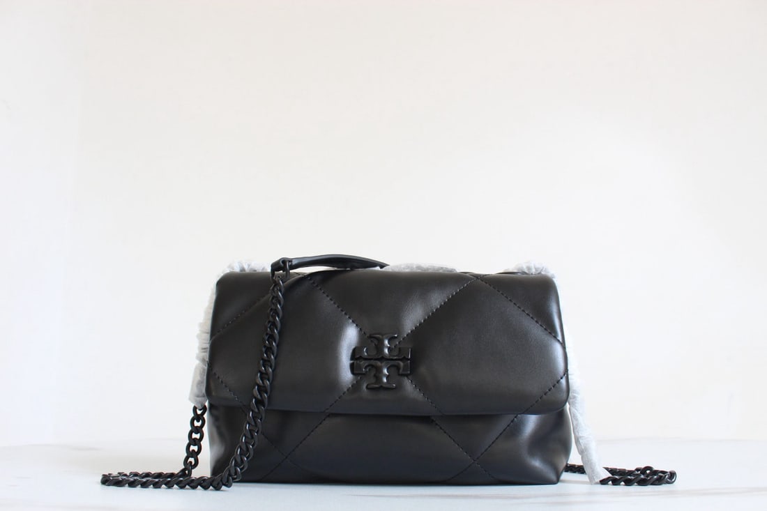 Tory Burch Kira: We offer FREE SHIPPING for both domestic and international clients who bid over $500. The Tory Burch Kira Cloud Bag, a leather flap bag, features a voluminous diamond-quilted design that gives the cla