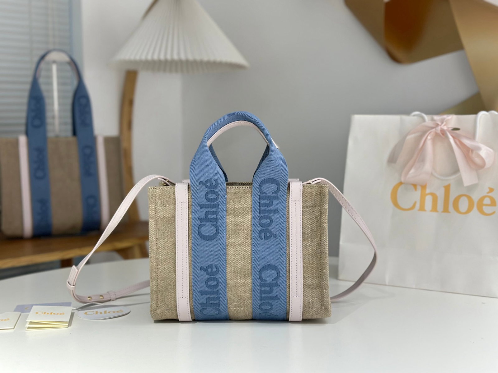 Chloe woody Tote: We offer FREE SHIPPING for both domestic and international clients who bid over $500. The Chloe Woody Tote in creamy pink with blue webbing is absolutely gorgeous. The bag is made of eco-friendly, dur
