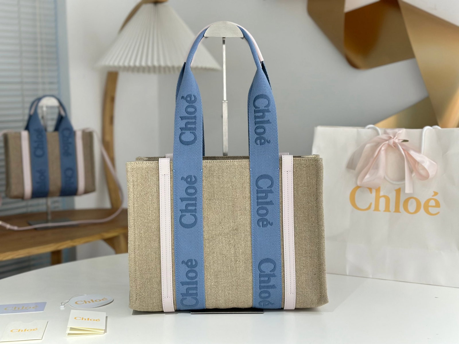 Chloe woody Tote: We offer FREE SHIPPING for both domestic and international clients who bid over $500. The Chloe Woody Tote in creamy pink with blue webbing is absolutely gorgeous. The bag is made of eco-friendly, dur
